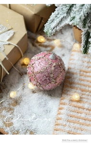 Detailed close-up of pink Christmas bauble with sequins and beads for holiday decor