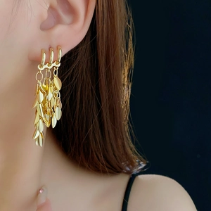 Golden wheat-shaped tassel earrings featuring multi-layered leaf design on model