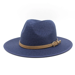 Detailed close-up of navy woven fedora hat with brown leather band and gold metal buckle