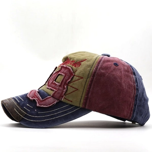 Close-up of vintage washed cotton baseball cap with patchwork design and 9 embroidery
