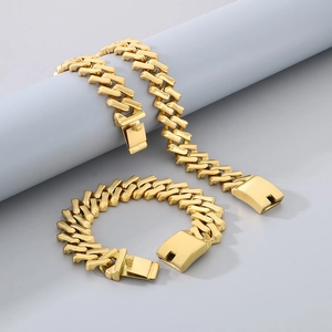 Golden 20mm Cuban link necklace and bracelet set displayed on a minimalist grey pedestal