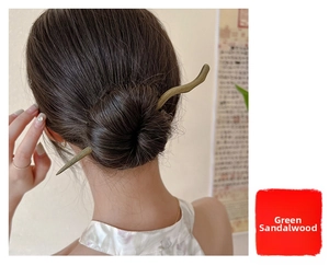 Green sandalwood hair stick styled in a low bun for a vintage traditional look