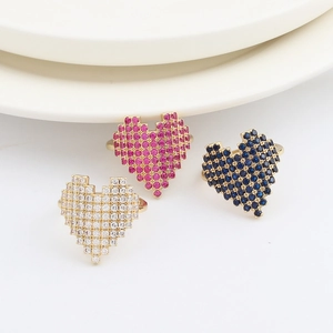 Detailed view of pixelated heart rings with pavé crystals in white, pink and blue