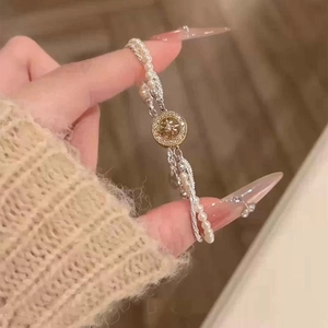 Detailed view of elegant freshwater pearl bracelet with starburst zircon charm