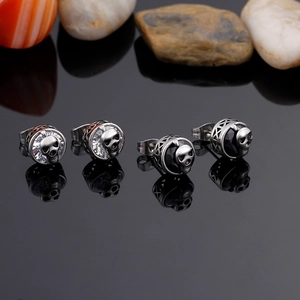 Punk style skull stud earrings with zircon stones and polished steel finish