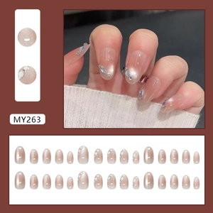 Sparkling pink cat eye press-on nails with glitter diamonds in medium oval shape