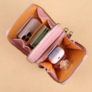 Pink multi-compartment crossbody phone bag for women showing spacious interior storage
