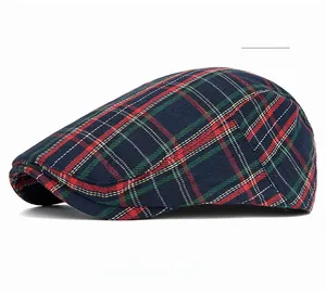 Detail view of the navy plaid flat cap featuring a classic woven textured fabric