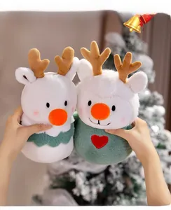 Close-up of plush Christmas reindeer dolls with orange noses and heart embroidery