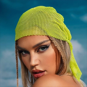 Close-up of neon green rhinestone mesh headpiece for festivals with clear blue sky backdrop