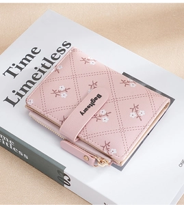 Close-up of pink folding wallet with diamond lattice texture and white flower patterns