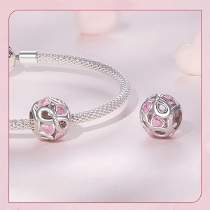 Close-up of S925 sterling silver MOM heart charm with pink cubic zirconia and engraving