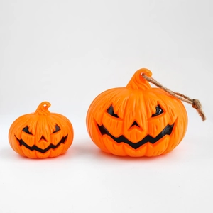 Two orange Halloween Jack-o'-lantern LED lights in different sizes on white background