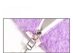 Detail view of purple plush fabric with white wide zipper and silver metal slider