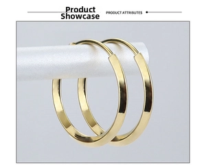 Polished golden titanium steel hoop earrings displayed on a minimalist jewelry stand