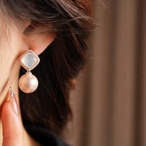Detailed shot of square cubic zirconia flower earrings with premium white pearls