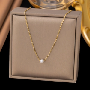 Elegant gold-plated stainless steel necklace with a round white pearl on a display box