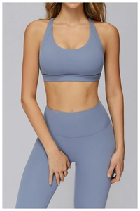 Detail of high-waist yoga set in foggy blue featuring a racerback bra and sculpting leggings