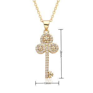 Detailed view showing a 28mm by 13mm gold key pendant with sparkling white crystals