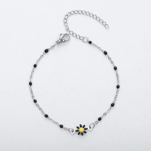 Detail view of silver daisy charm bracelet with black beads and adjustable lobster clasp