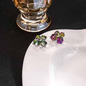 Macro detail of aurora crystal cube earrings showing prismatic geometric glass texture