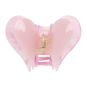 Detail of pink double heart hair claw clip with acetate finish and marble texture
