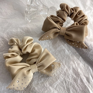 Elegant velvet scrunchies with rhinestone bows in beige and khaki colors for women