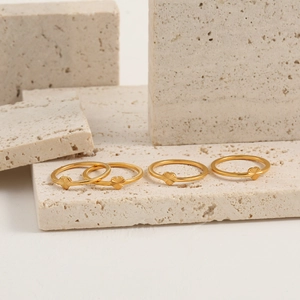 French vintage laser heart gold titanium steel rings displayed on travertine stone