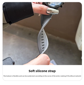 Flexible grey silicone watch strap detail showing durable texture and adjustment holes