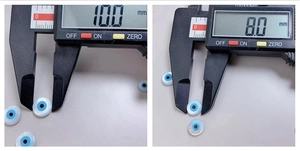 Detail showing 10.0mm and 8.0mm shell evil eye beads with caliper measurement