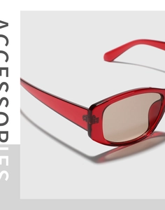 Detail view of red translucent frame and durable hinges on fashion square sunglasses