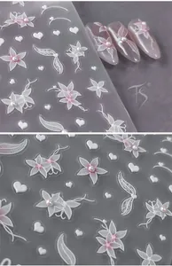 Detail of 5D embossed flower nail stickers with 3D lace hearts and pearl accents