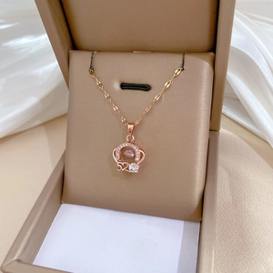 Close-up of rose gold necklace with crown 520 dancing stone in a gift box