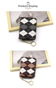 Close-up of argyle patterned leather card holders with gold zippers and keychains