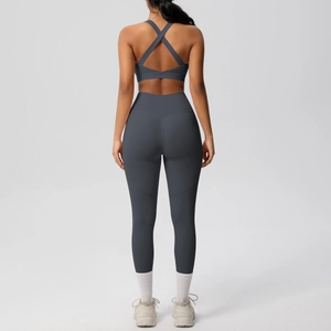 Rear view of deep gray high-waisted yoga set featuring cross-strap bra and slimming leggings