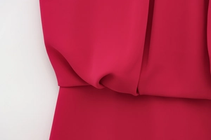Detail of fuchsia summer romper showing high-quality chiffon fabric texture and stitching