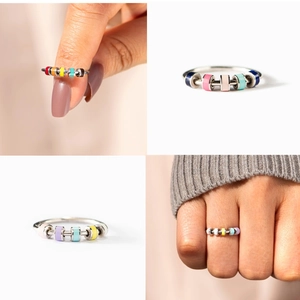 Detail of spinning enamel beads on silver stainless steel anti-anxiety spinner ring