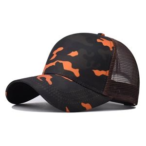Detail view of camouflage trucker hat with orange patterns and breathable brown mesh back