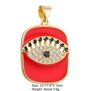 Macro shot of gold-plated red enamel evil eye tarot pendant with zircon details