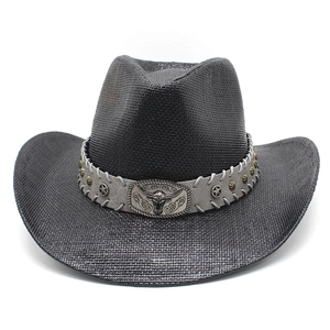 Detail of black straw cowboy hat with leather band, bull head buckle and star rivets