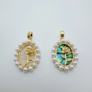 Close-up of vintage oval rose charms with white pearl inlay and abalone shell finish