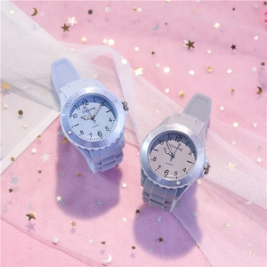 Close-up of pastel silicone kids watches on pink starry mesh background fabric