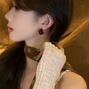 Maillard brown resin teardrop earrings on model with elegant silver needle drop style