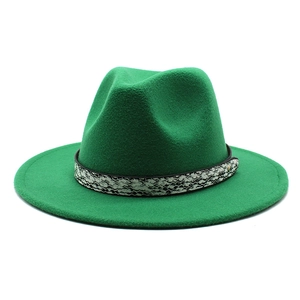 Detailed macro view of bright green wool fedora with snakeskin band and gold studs