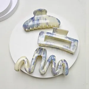 Three-piece hair claw clip set with cream and blue floral water transfer print