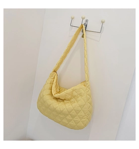 Detail showing yellow quilted space cotton tote bag texture and soft puffy design