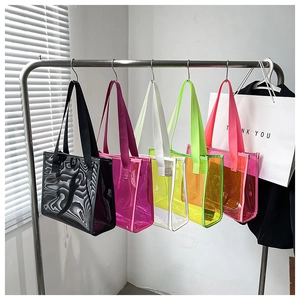 Colorful large transparent PVC tote bags displayed in multiple neon colors on a metal rack