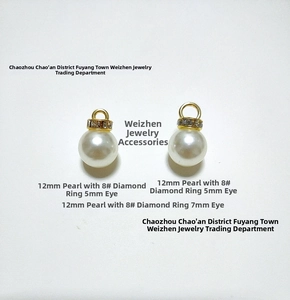 Detailed view of 12mm white pearls with gold rhinestone caps and 5mm/7mm eyelets