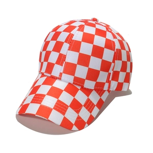 Detailed view of a red and white checkered baseball cap with a classic curved brim