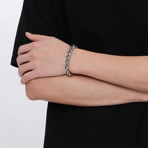 Polished 10mm stainless steel basket weave chain bracelet worn on a male wrist
